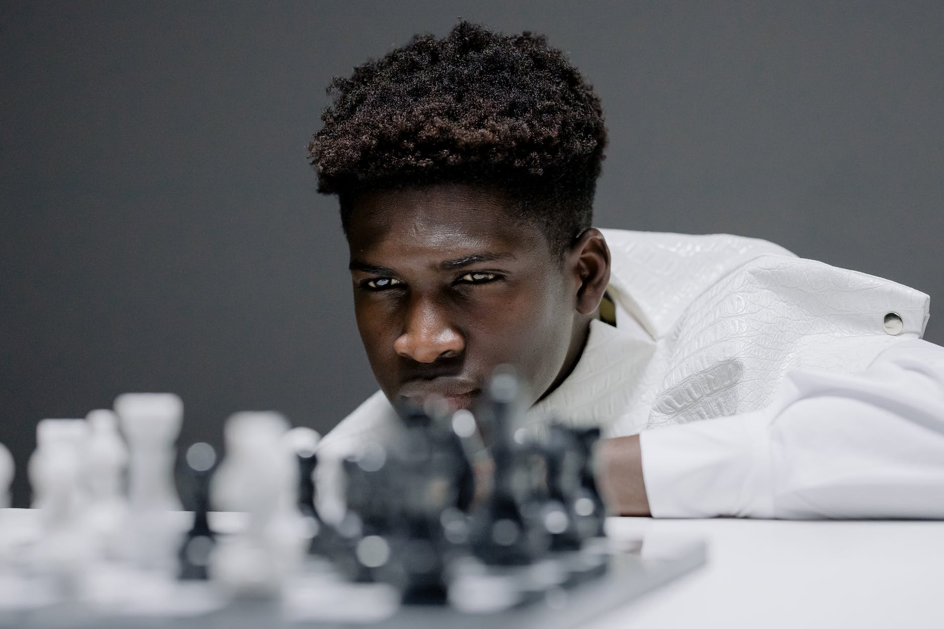 a man in white shirt playing chess