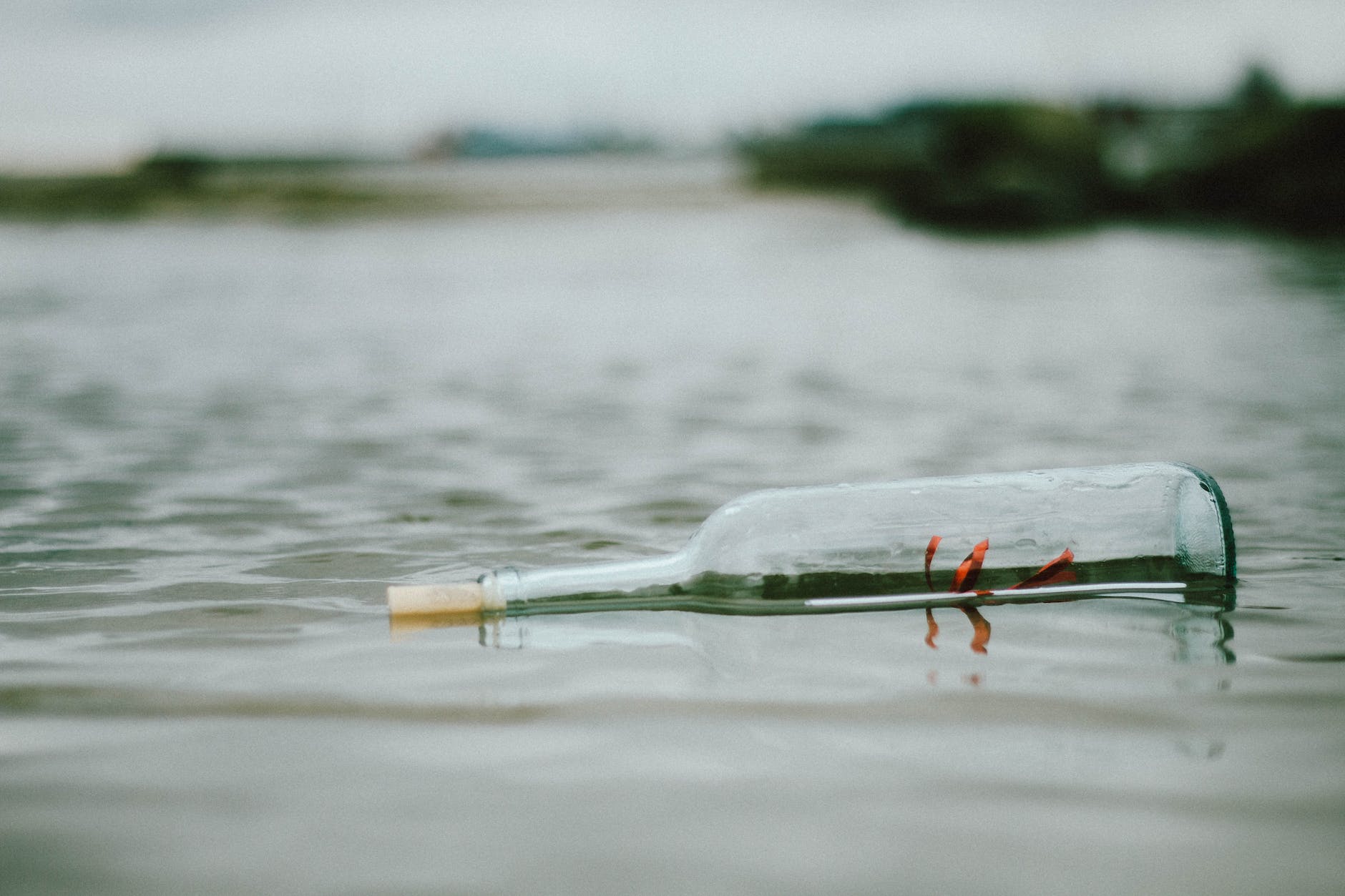selective focus photo of bottle floating on body of water